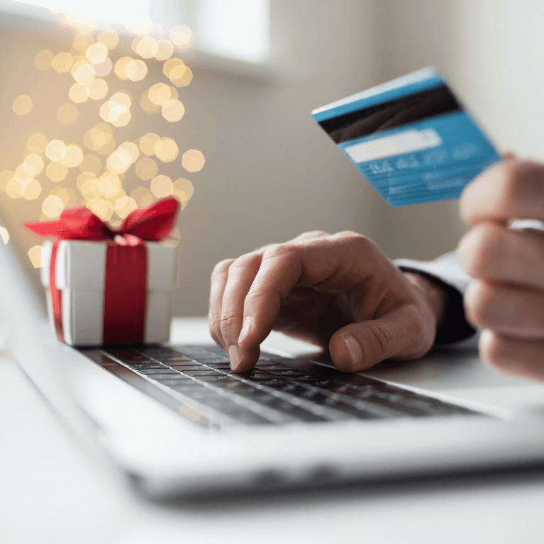 A gentleman entering his credit card information to complete his online purchase.