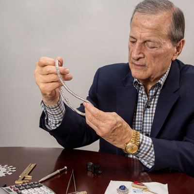 Jewelry expert holding necklace